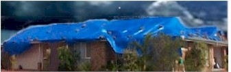 Tarp covering roof